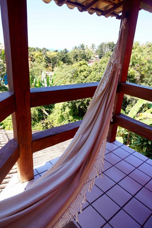 Novos Baianos Hostel E Pousada Porto Seguro Exterior foto A hammock hanging from a balcony
